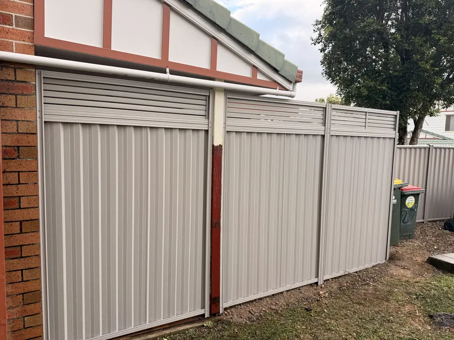Colorbond fence with a horizontal slat topper added for extra height and privacy